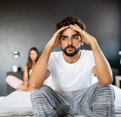 Unhappy couple having arguments and sexual problems in bed